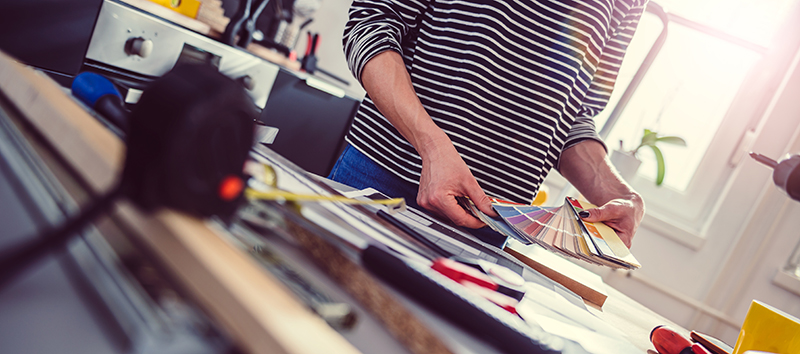 Woman selecting paint colors for kitchen renovation