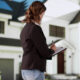 Buyer evaluating an occupied home from the street before bidding at a foreclosure auction